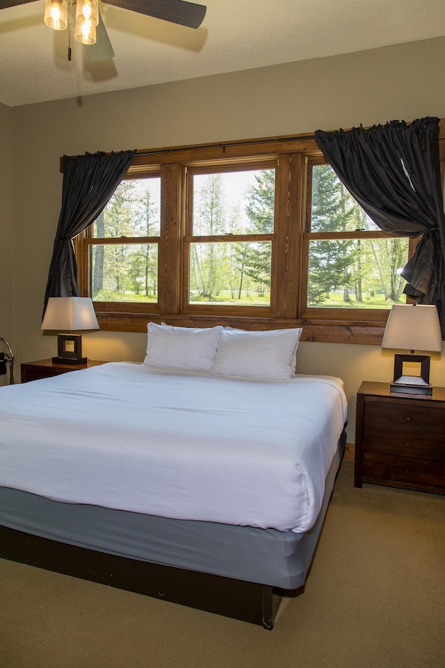 bedroom featuring light carpet and ceiling fan