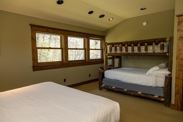 bedroom featuring carpet floors, lofted ceiling, and multiple windows