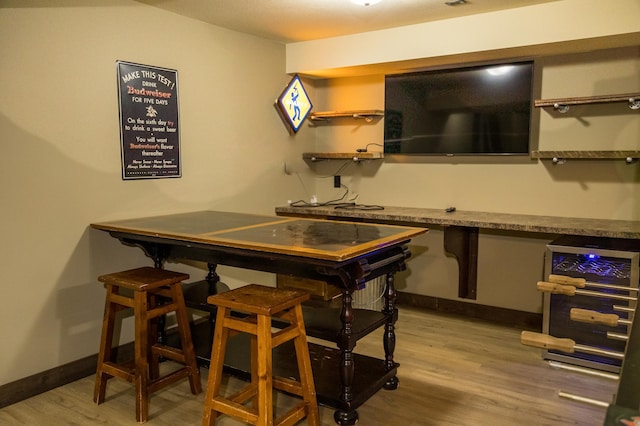 33816 County Road 3, Crosslake, MN 56442 - bar with light wood-style flooring, beverage cooler, and baseboards