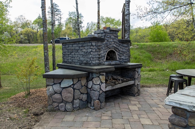 view of patio with a stone fireplace