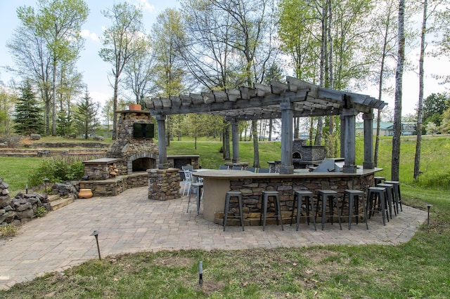 33816 County Road 3, Crosslake, MN 56442 - view of patio with an outdoor stone fireplace and a pergola