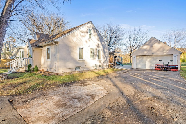 view of property exterior featuring an outbuilding and a garage