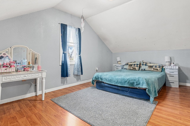 bedroom with hardwood / wood-style flooring and vaulted ceiling