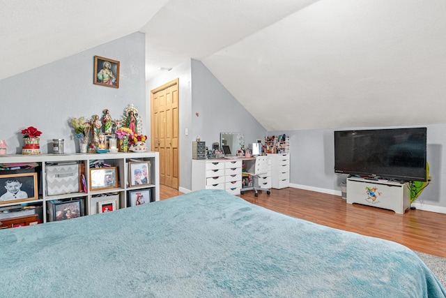 bedroom featuring wood-type flooring and lofted ceiling