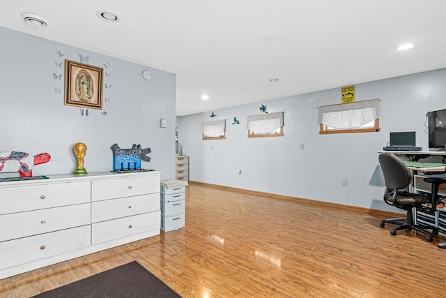 office area with light hardwood / wood-style floors