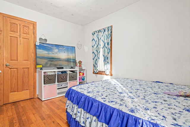 bedroom with hardwood / wood-style flooring