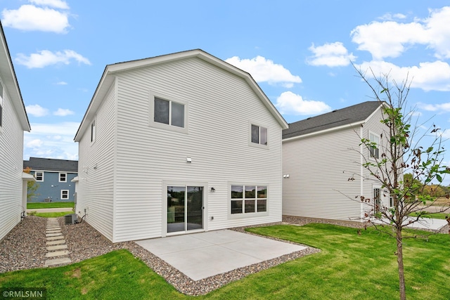 rear view of property with a patio area, central air condition unit, and a yard