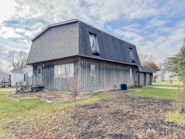 view of home's exterior with a garage and a yard