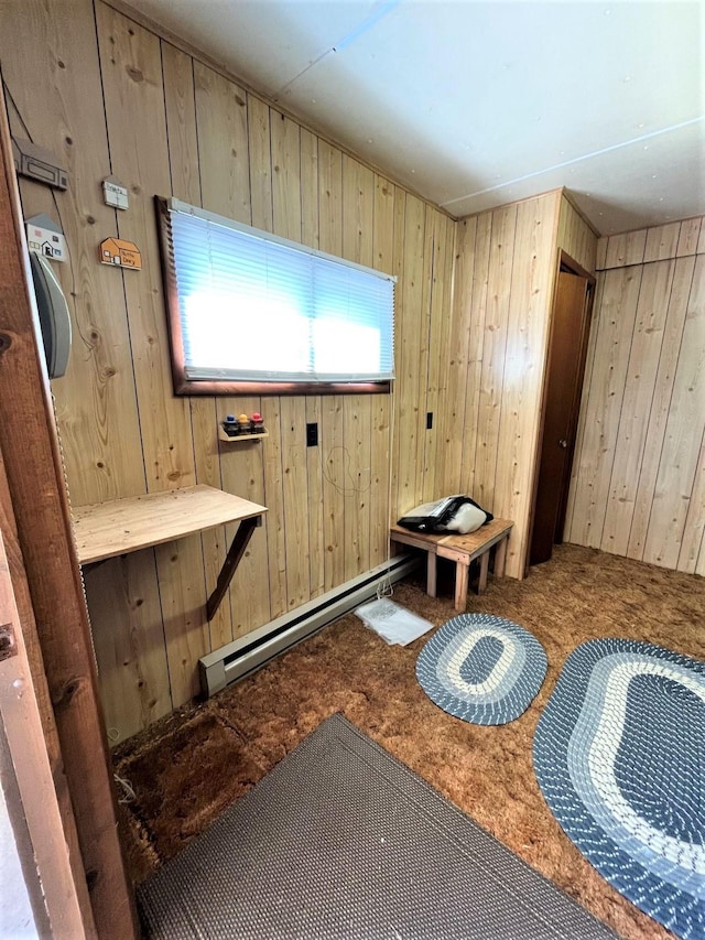 bathroom featuring baseboard heating and wooden walls