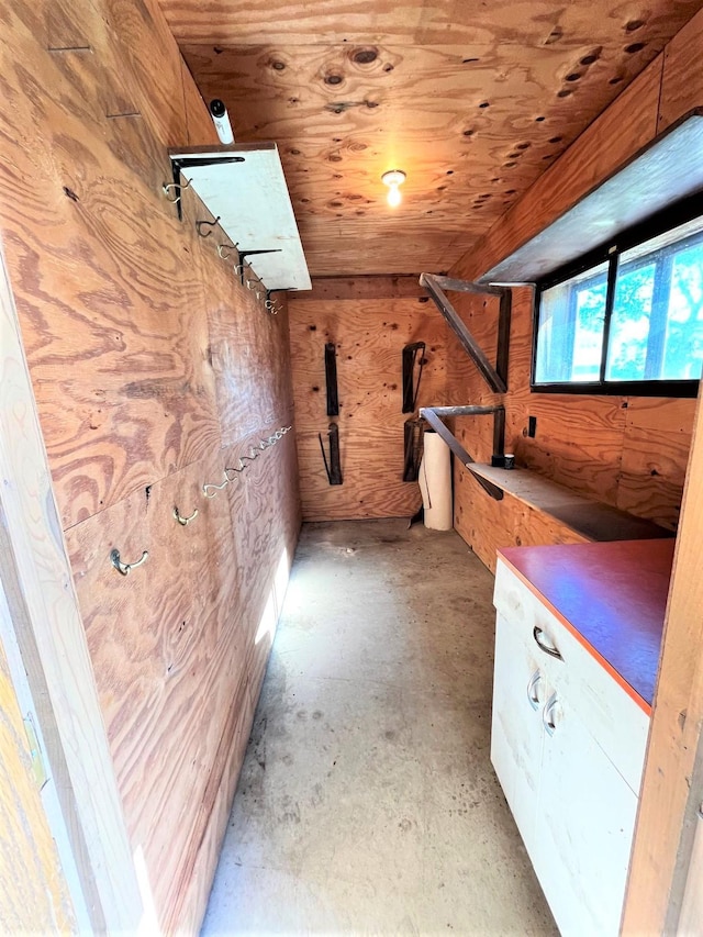 bonus room with wooden ceiling and wooden walls