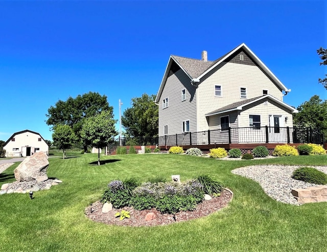 exterior space featuring a lawn and a deck