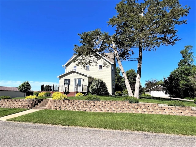 view of front of house featuring a wooden deck and a front lawn