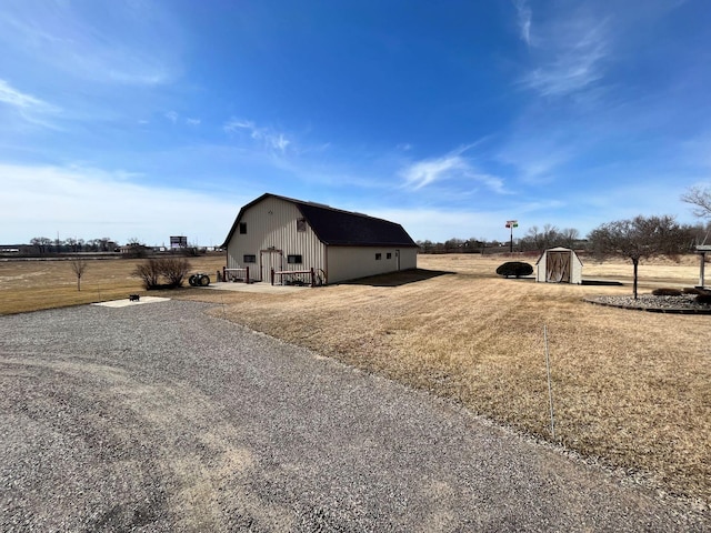 view of property exterior with a lawn and an outbuilding