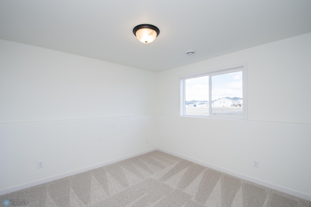 6652 32nd St S, Fargo, ND 58104 - empty room featuring baseboards and light carpet