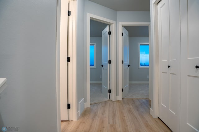 corridor with light wood-type flooring