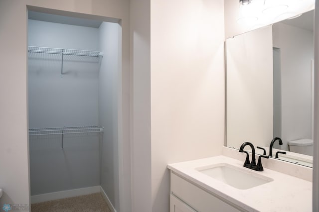 bathroom with toilet and vanity