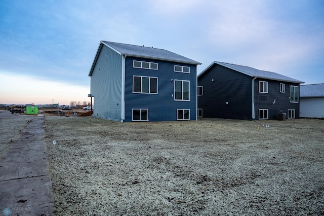 view of back house at dusk