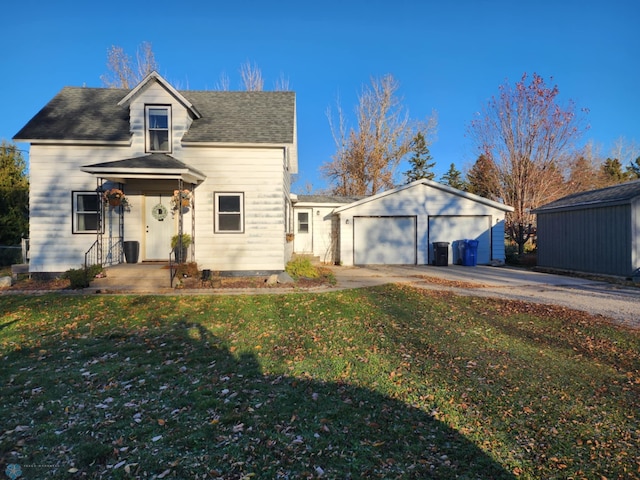 view of front of house featuring a garage, driveway, and a front lawn