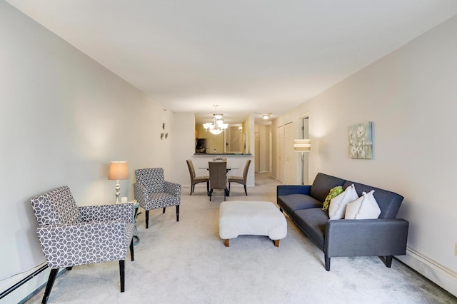 carpeted living room featuring baseboard heating and an inviting chandelier