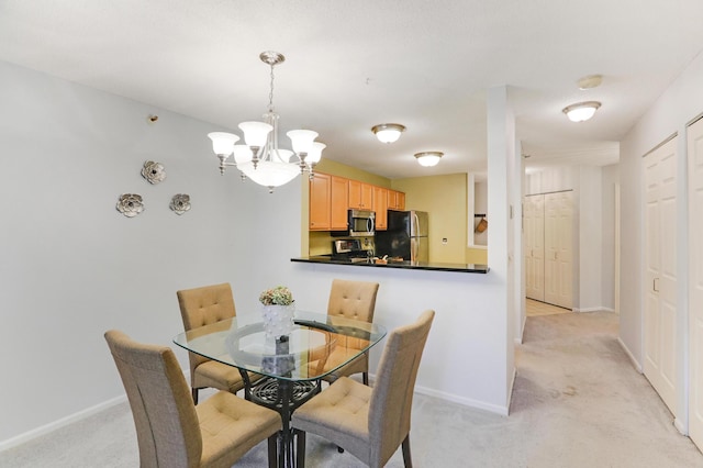 dining room featuring light carpet and an inviting chandelier