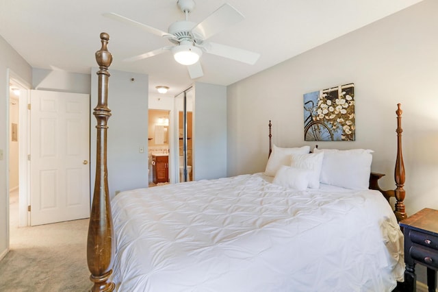 carpeted bedroom with connected bathroom and ceiling fan