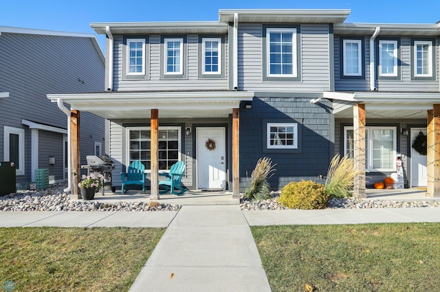 view of front of home featuring a porch and cooling unit