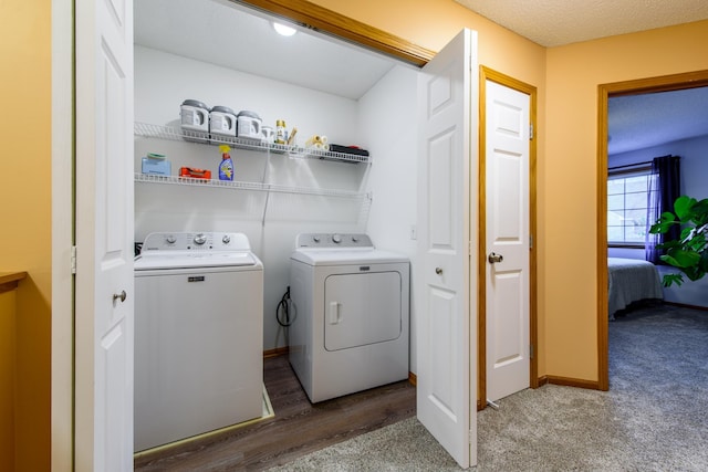 clothes washing area with a textured ceiling, hardwood / wood-style flooring, and independent washer and dryer