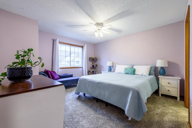 carpeted bedroom featuring ceiling fan and a textured ceiling