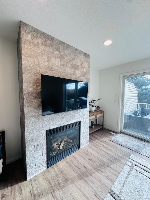 living room with hardwood / wood-style floors and a fireplace