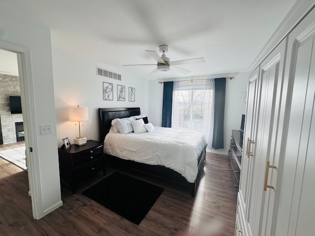 bedroom with ceiling fan and dark hardwood / wood-style flooring