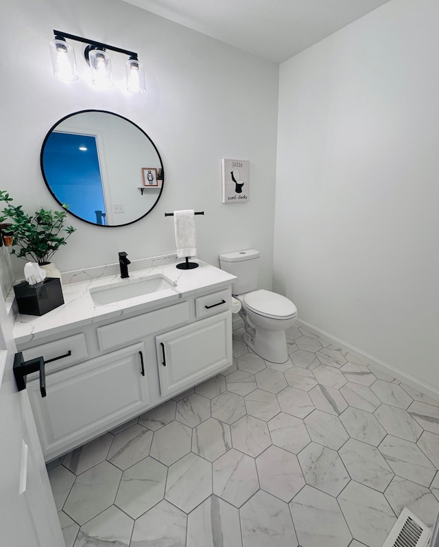 bathroom with vanity and toilet