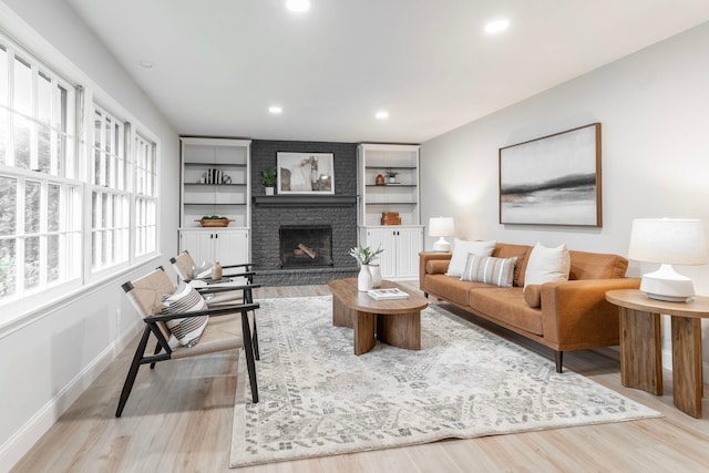 living room featuring light hardwood / wood-style floors and a fireplace