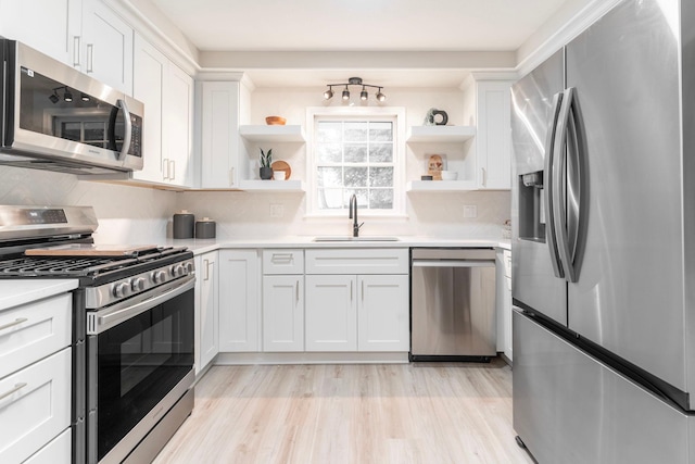 kitchen featuring white cabinetry, stainless steel appliances, and sink