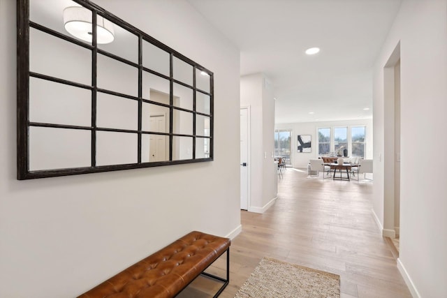 hallway with light hardwood / wood-style flooring