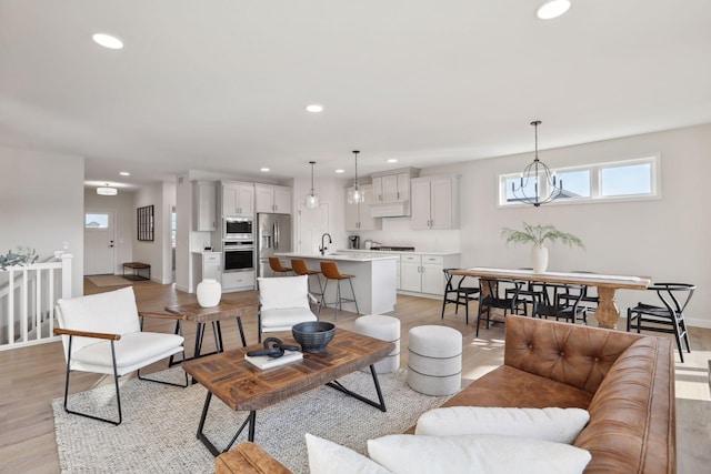 living room featuring light hardwood / wood-style floors and sink