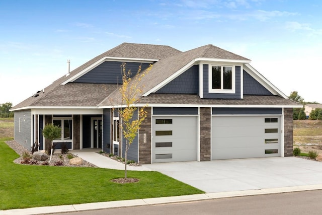 view of front of house featuring a garage and a front yard