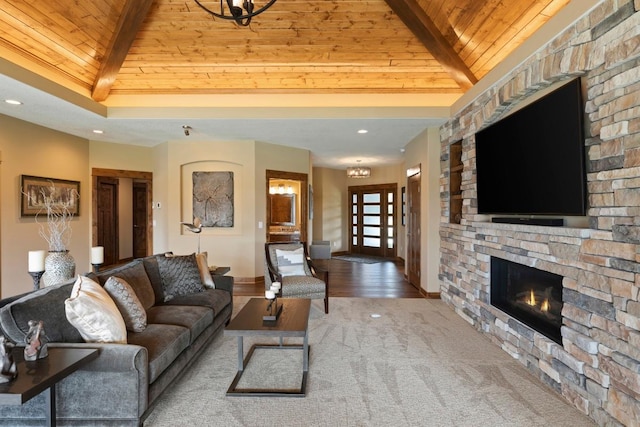 living room featuring hardwood / wood-style floors, a fireplace, beam ceiling, and wood ceiling