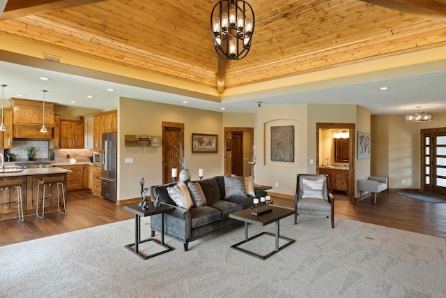 living room featuring wooden ceiling, wood-type flooring, and a notable chandelier