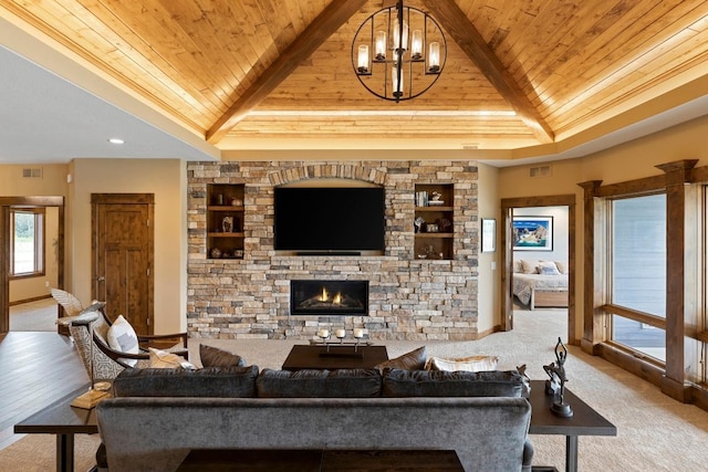 living room featuring built in shelves, an inviting chandelier, a stone fireplace, wood ceiling, and light hardwood / wood-style flooring