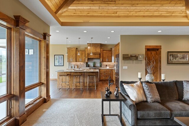 living room with wooden ceiling, beamed ceiling, and dark wood-type flooring