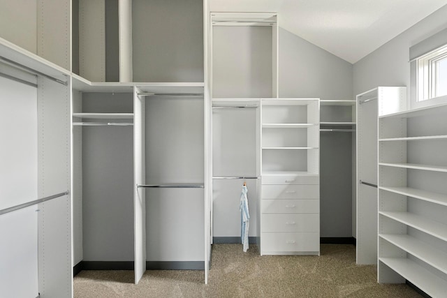 spacious closet with carpet and lofted ceiling