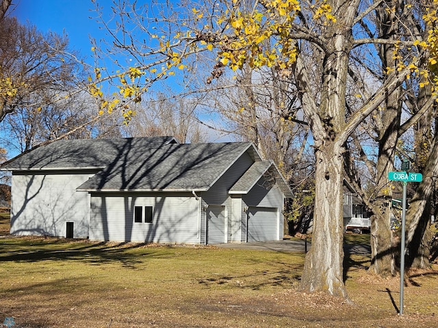 view of property with a front yard and a garage