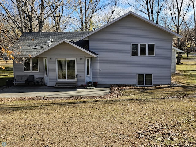 back of property featuring a yard and a patio area