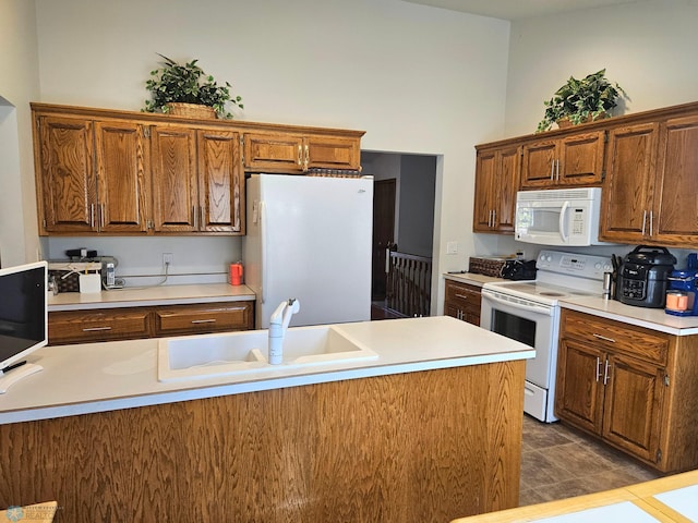 kitchen featuring white appliances and sink