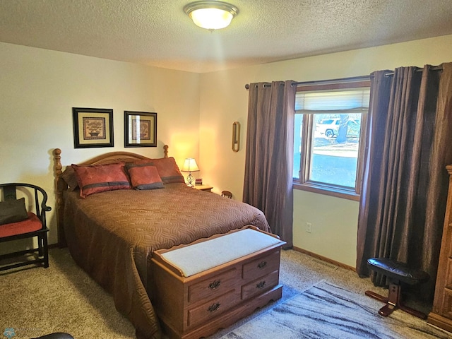 bedroom featuring a textured ceiling and light colored carpet