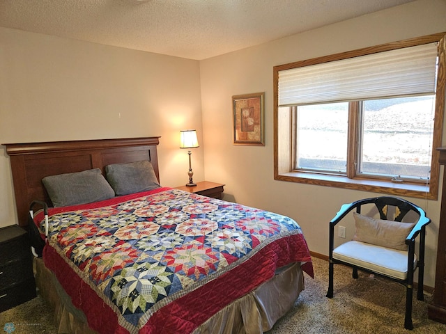 bedroom with a textured ceiling and carpet flooring