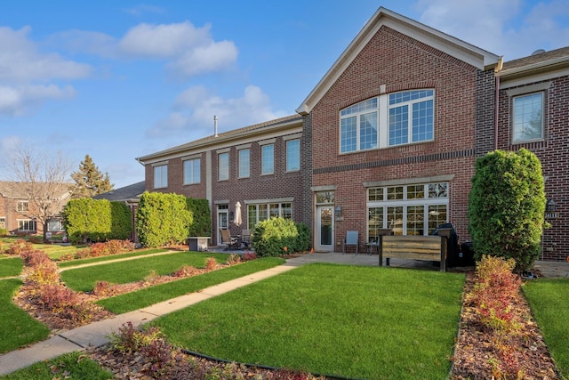 view of front of home with a front lawn and a patio area