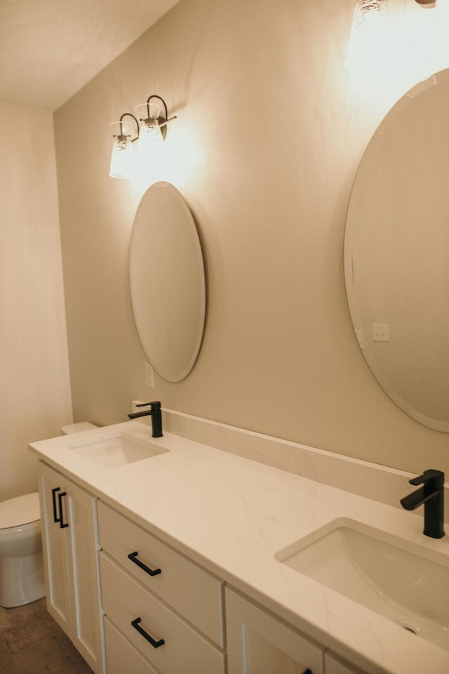 bathroom with vanity and toilet