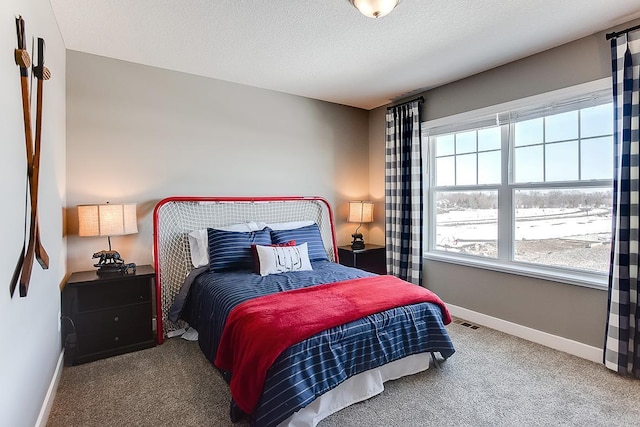 carpeted bedroom with a textured ceiling