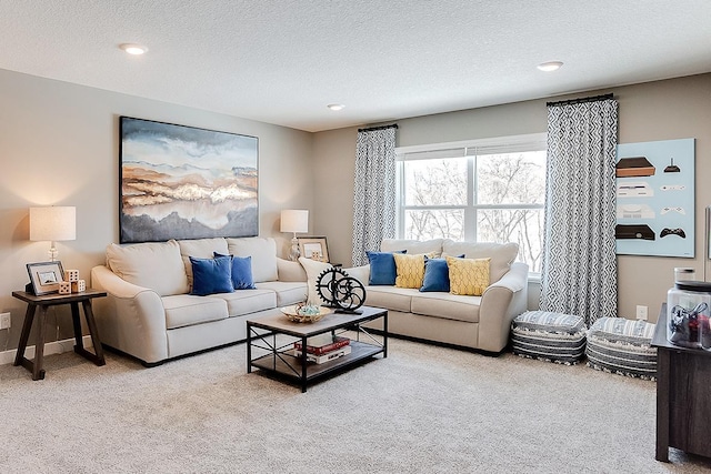 living room featuring carpet and a textured ceiling